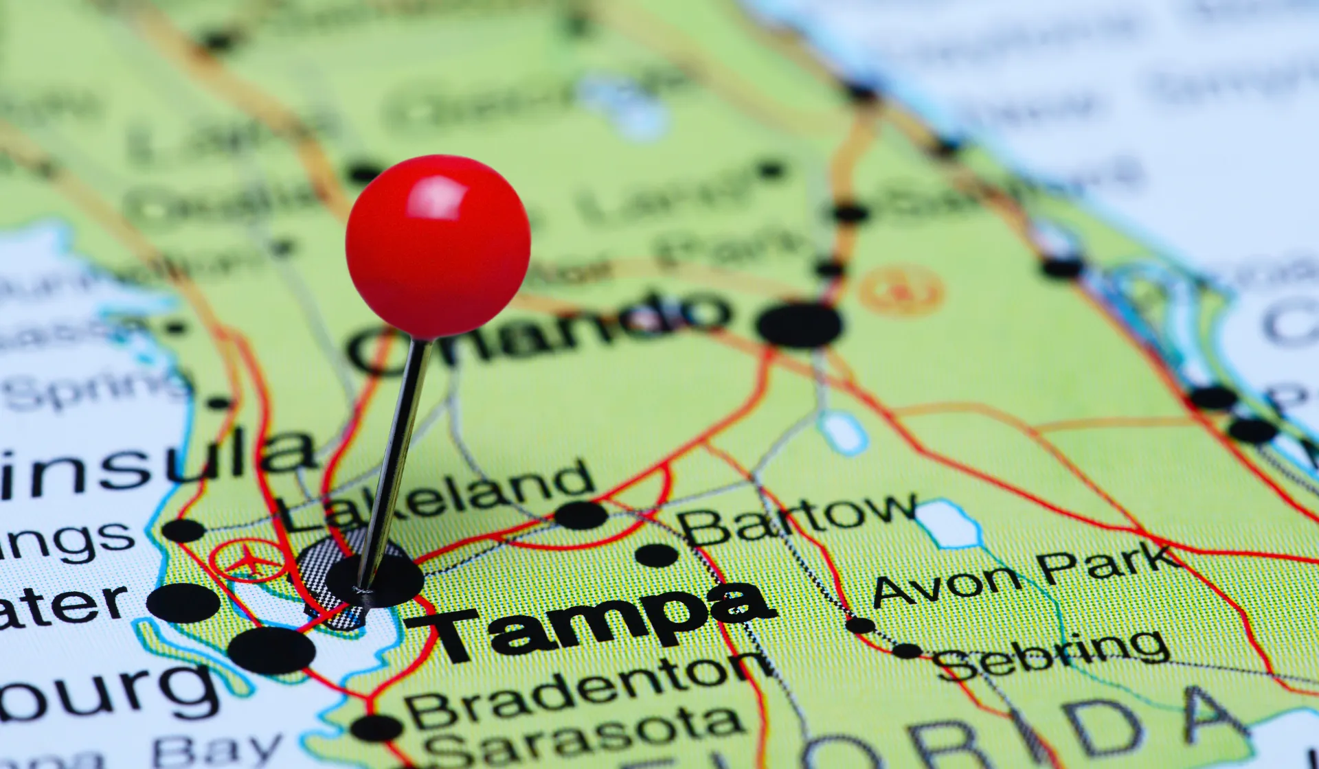 Digital marketing specialist managing Tampa PPC campaigns on a computer monitor showing Google Ads and Meta Ads dashboards, representing LeadGulls hands-on approach to pay-per-click management for Florida businesses